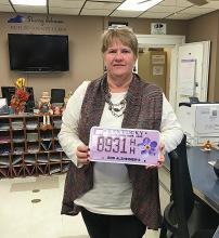 Butler County Clerk Sherry Johnson shows the specialty plate.