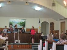 Lydia Wells leads choir.
