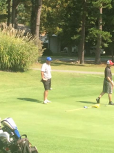 Clay Johnson waits for his group after he chipped in for birdie.