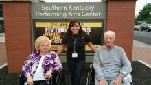 Bonnie McKinney, QOL Assistant: Leah Tucker, and Elder James Hunter pose for a picture outside SKYPAC before the Glenn Miller Orchestra concert.
