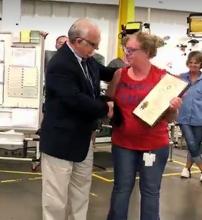 Randa Cameron accepts the award from Labor Cabinet Deputy Secretary Mike Nemes