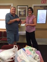 Fred Tate presents school supplies to Family Resource Center.