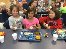 NBES students enjoy food from their garden.