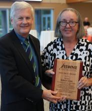 ISWNE Executive Director Chad Stebbins presents the Don Brod Award to Dr. Deborah T. Givens.