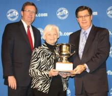 Betty Farris (center), president of Butler County Farm Bureau, accepts the “Top County” award from David S. Beck, KFB Executive Vice President (right), and Bradley R. Smith, KFB Insurance Companies Chief Executive Officer (left).