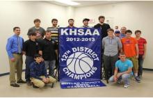  The Varsity Team next to their 12th District Championship Banner.