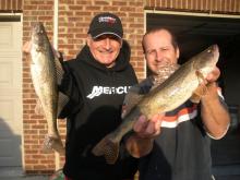 Ryan Oster (right) and his father Joe, (left) hold two sauger measuring about 18 inches caught from below Lock and Dam 6 on the Kentucky River in central Kentucky. 