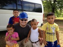 Chase Goff with children in the village.