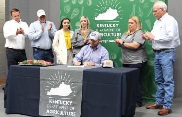 Kentucky Commissioner of Agriculture Jonathan Shell, seated, signs a proclamation commemorating May as Kentucky Beef Month. Joining Commissioner Shell at the event were representatives of the Kentucky Beef Council, Kentucky Cattlemen's Association, and the beef industry. For more photos from the event, click here. (Kentucky Department of Agriculture)